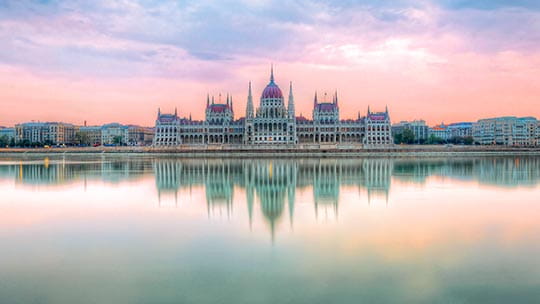 The Hungarian Parliament Building on the Danube river at sunset, Budapest